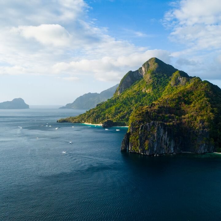 Breathtaking aerial view of El Nido, Philippines with lush islands and azure waters under a clear sky.